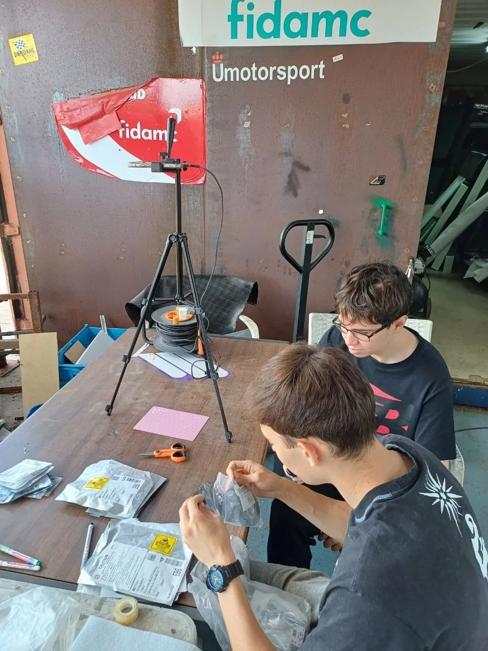 The team photographing components on a tripod rig