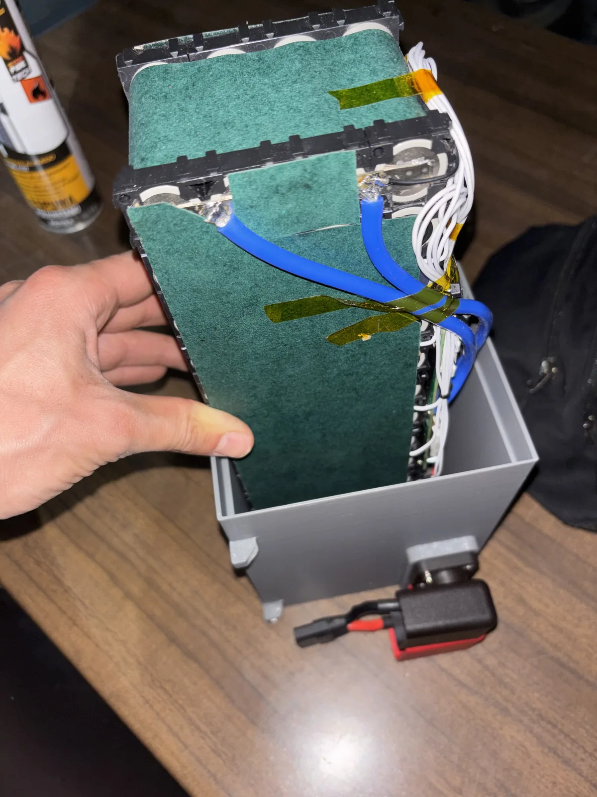 Lowering the pack into its 3D-printed enclosure